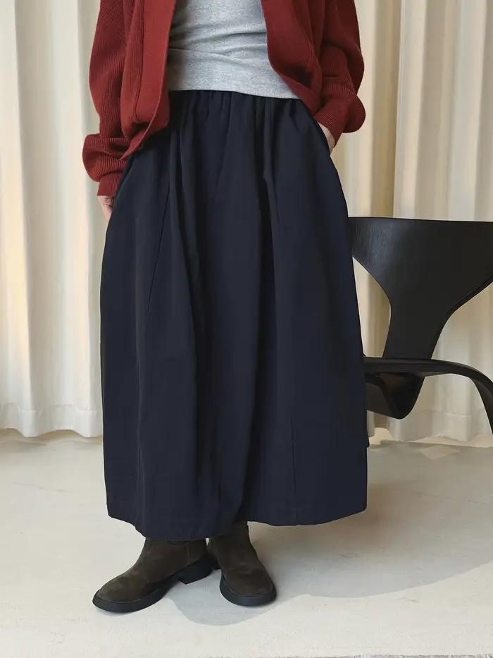 Début du printemps simple taille haute bouton élastique demi-jupe ample minceur décontracté jupe longue pour les femmes