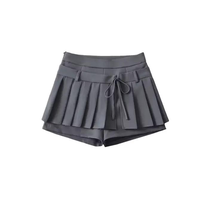 Mini-jupe plissée taille haute avec nœud papillon