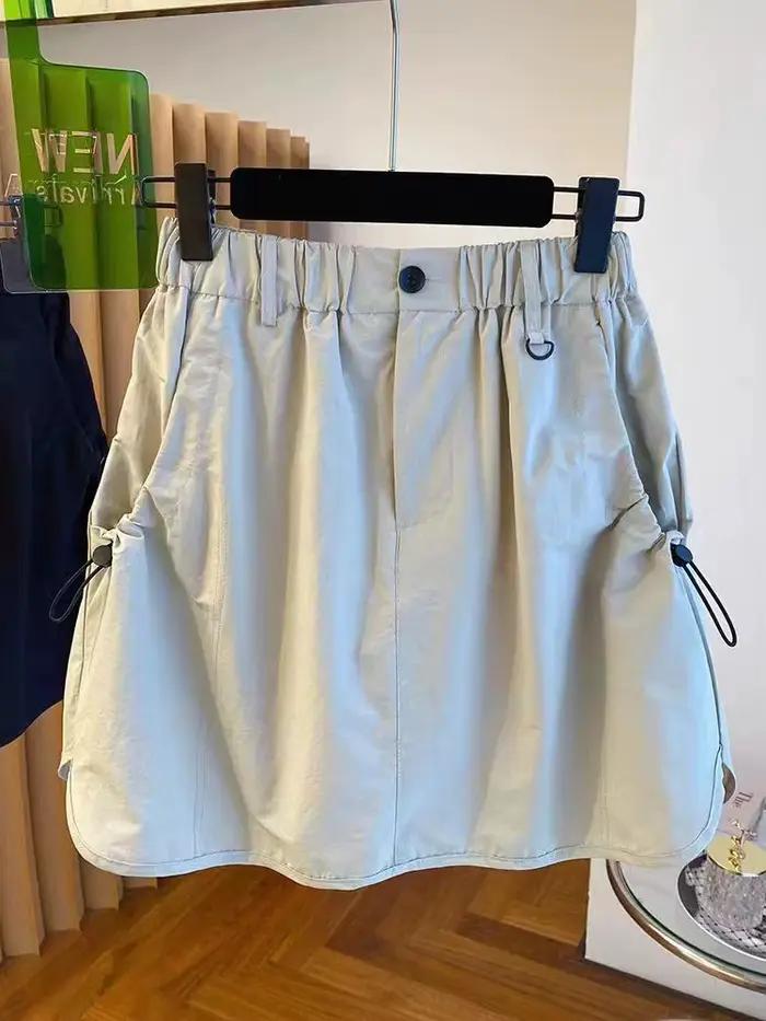 Version coréenne vêtements de travail jupe courte ample taille haute rétro décontracté tendance demi-longueur